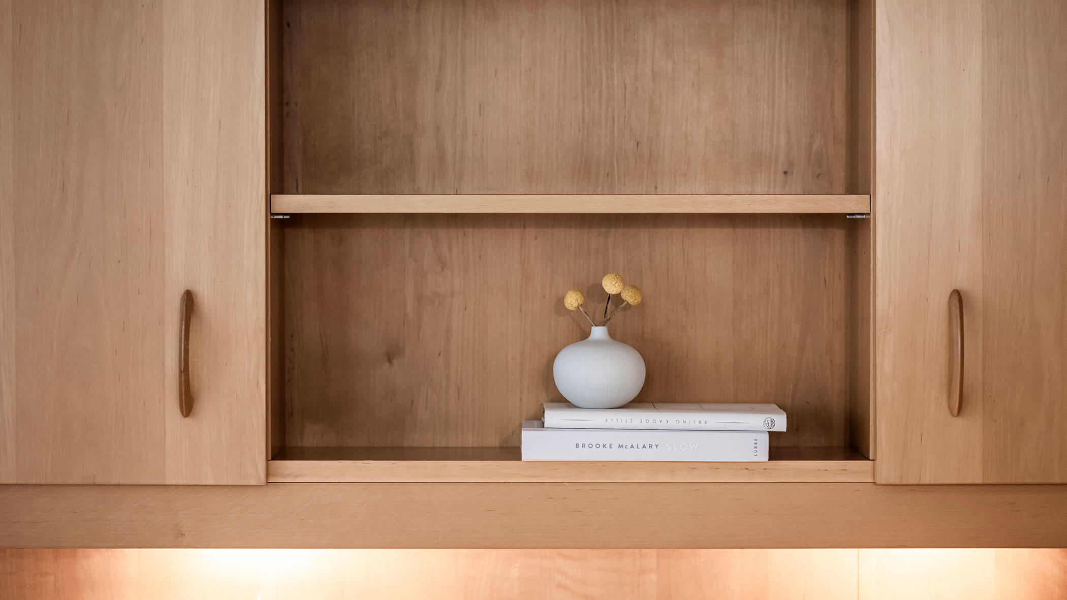 Libri e un vaso di fiori gialli su una mensola di legno - Residenza Kurze Wand