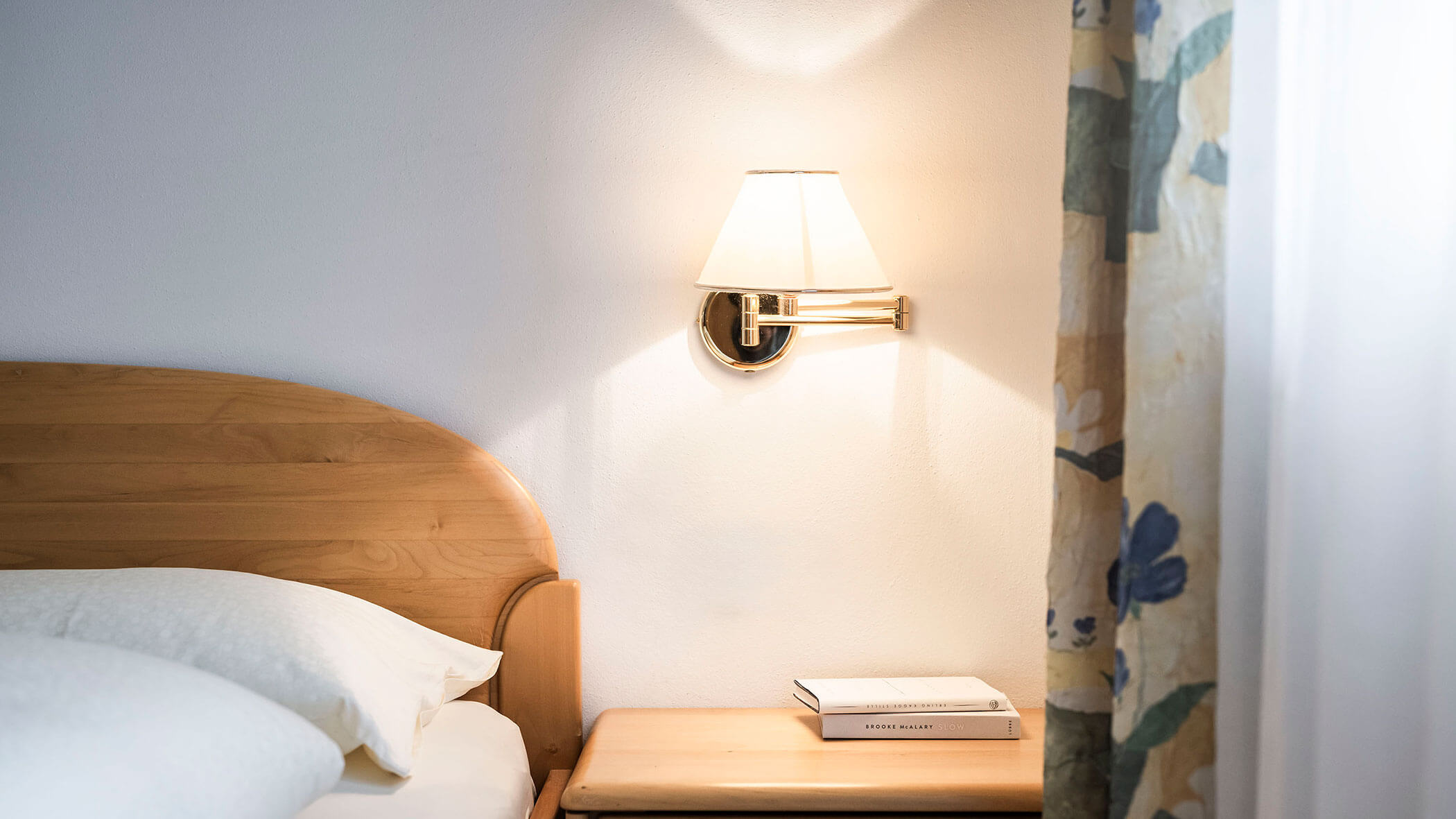 Letto in legno e comodino con due libri nell'appartamento 3 - Residence Kurze Wand